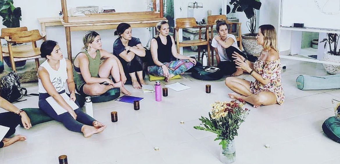 Sylvana Kozak leading a group session seated in a circle