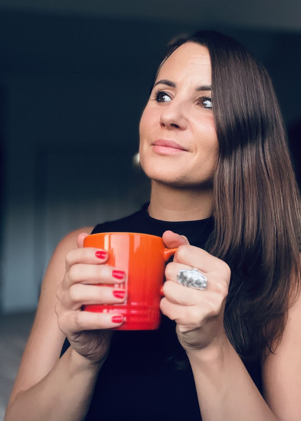 Sylvana Kozak holding a red coffee cup